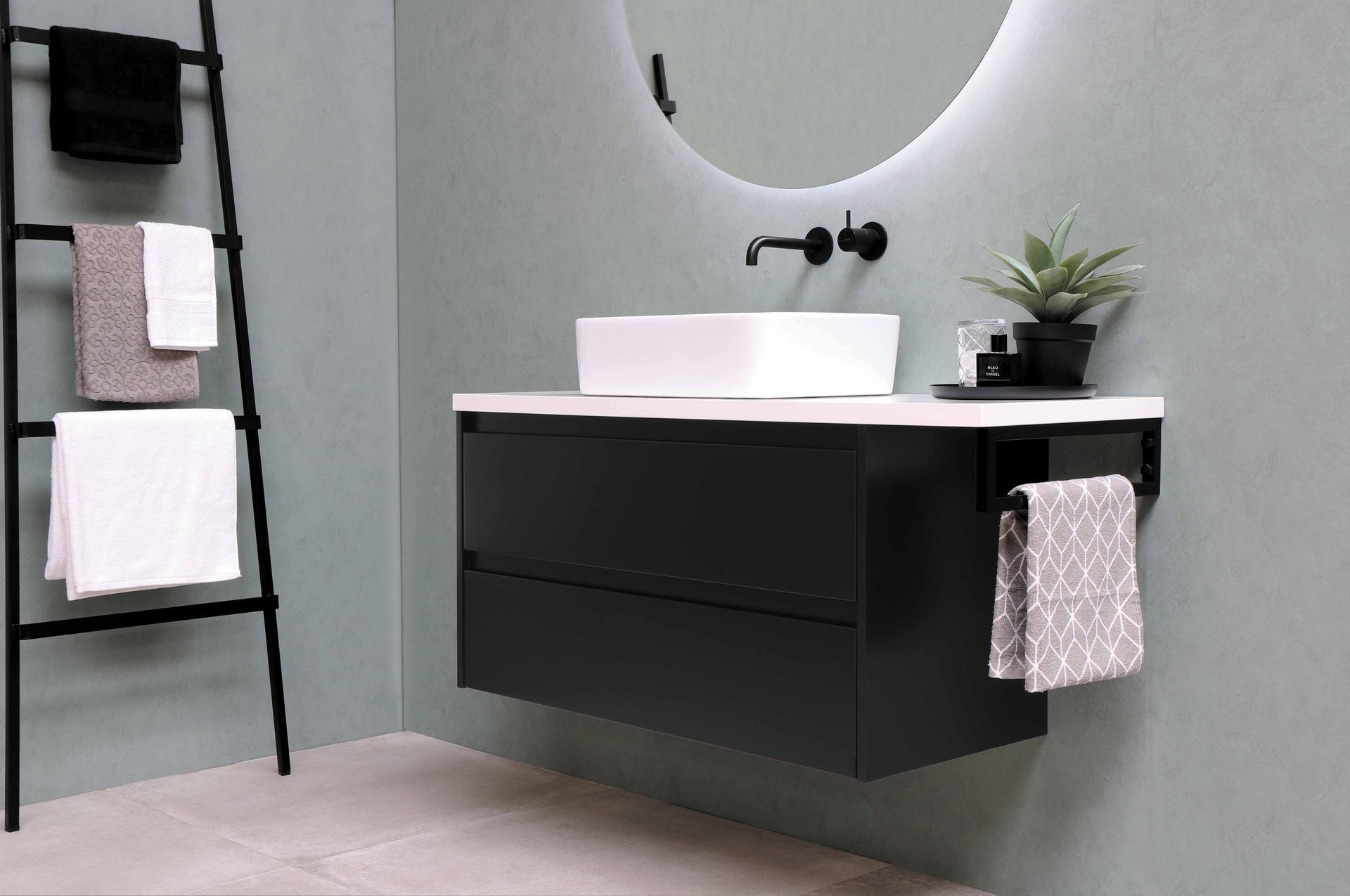 A bathroom with a sink , mirror and towel rack