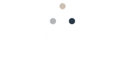 Three colored dots on a white background, arranged in a triangle. Stable Group Logo