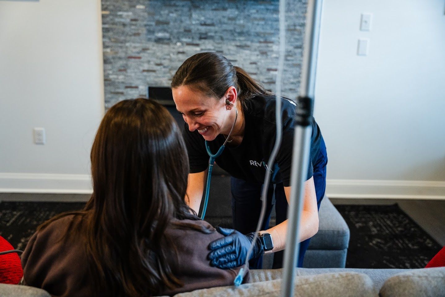 Revive employee helping the patient for IV transfusion