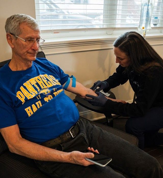 Revive  employee give medicine to an elder.