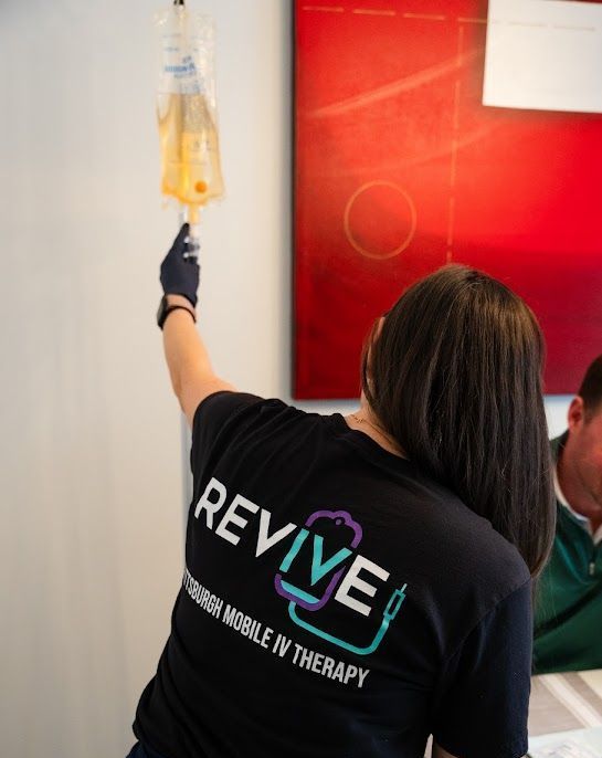 A woman wearing a black shirt that says revive