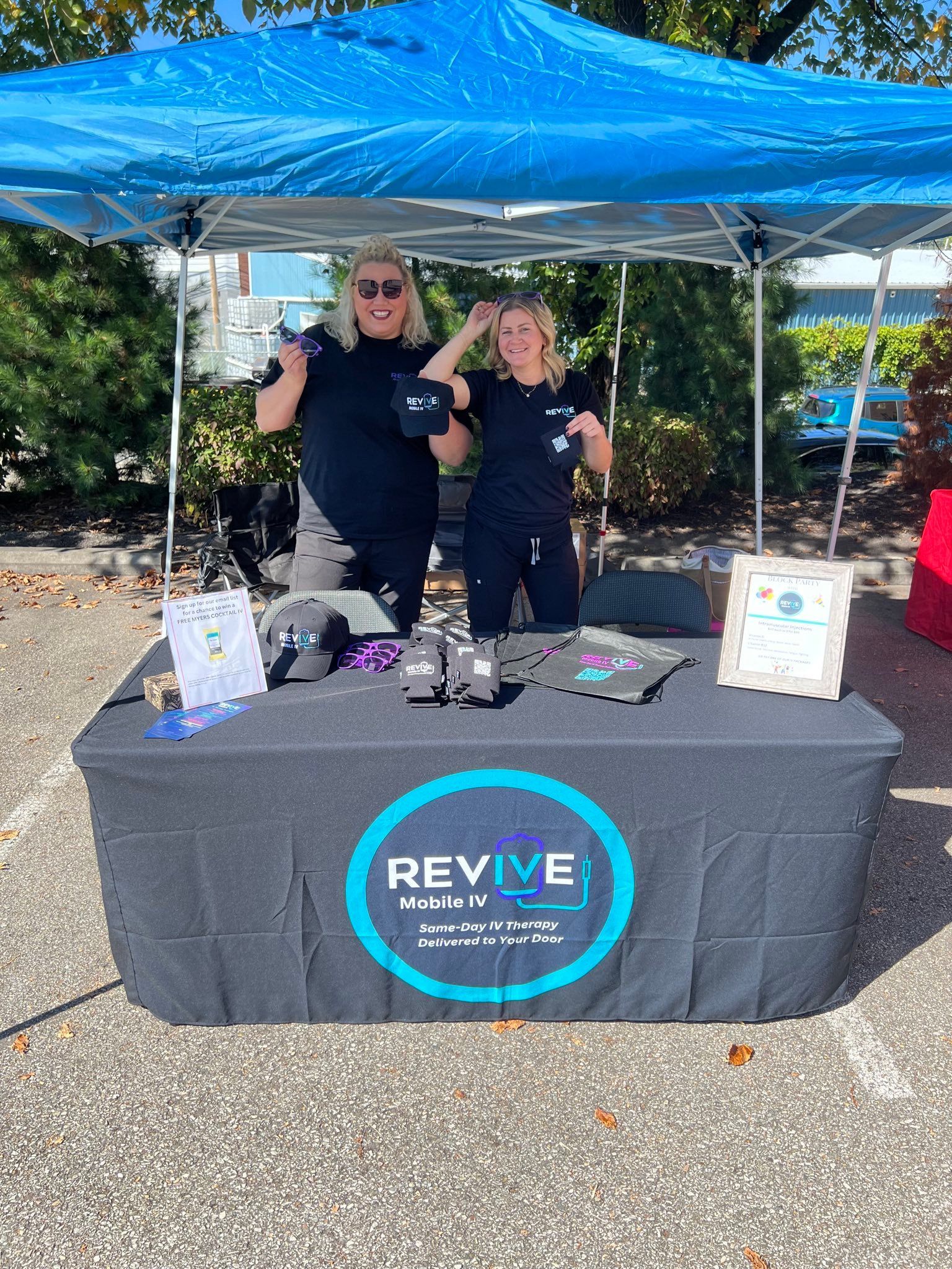 Two nurses at a community event tent