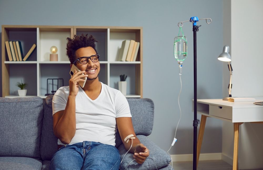 Client on the phone during in-home IV therapy