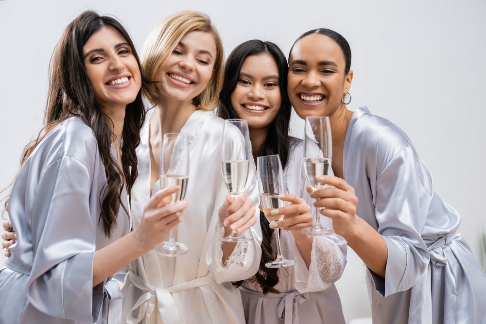 Bridal party celebrating with drinks before a wedding
