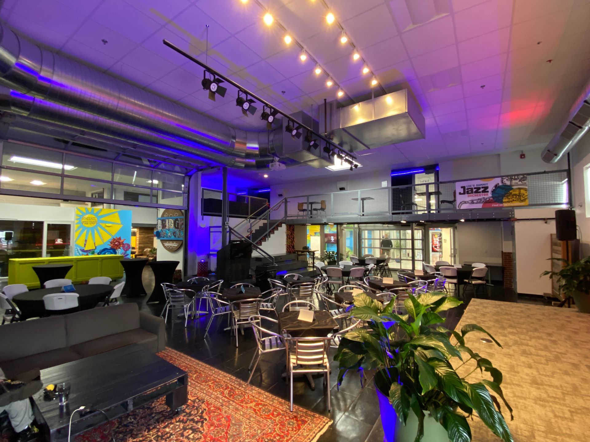 lees summit event space with plants chairs and tables and lighting