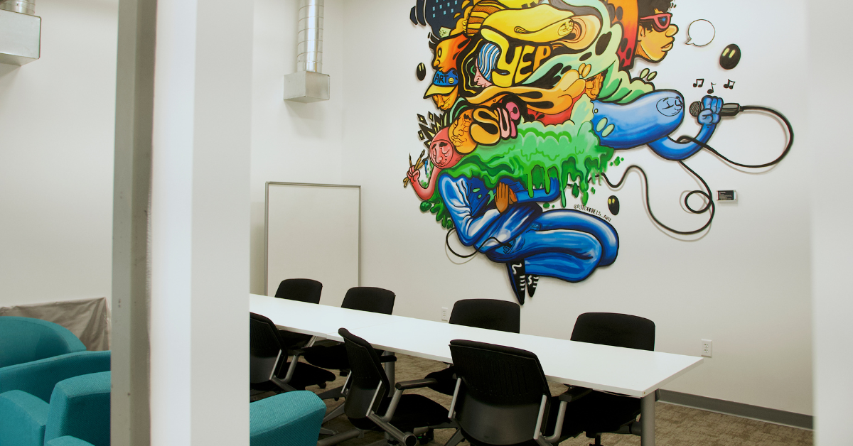 Modern meeting room in downtown Lee’s Summit at Bridge Space with large table, ergonomic chairs,