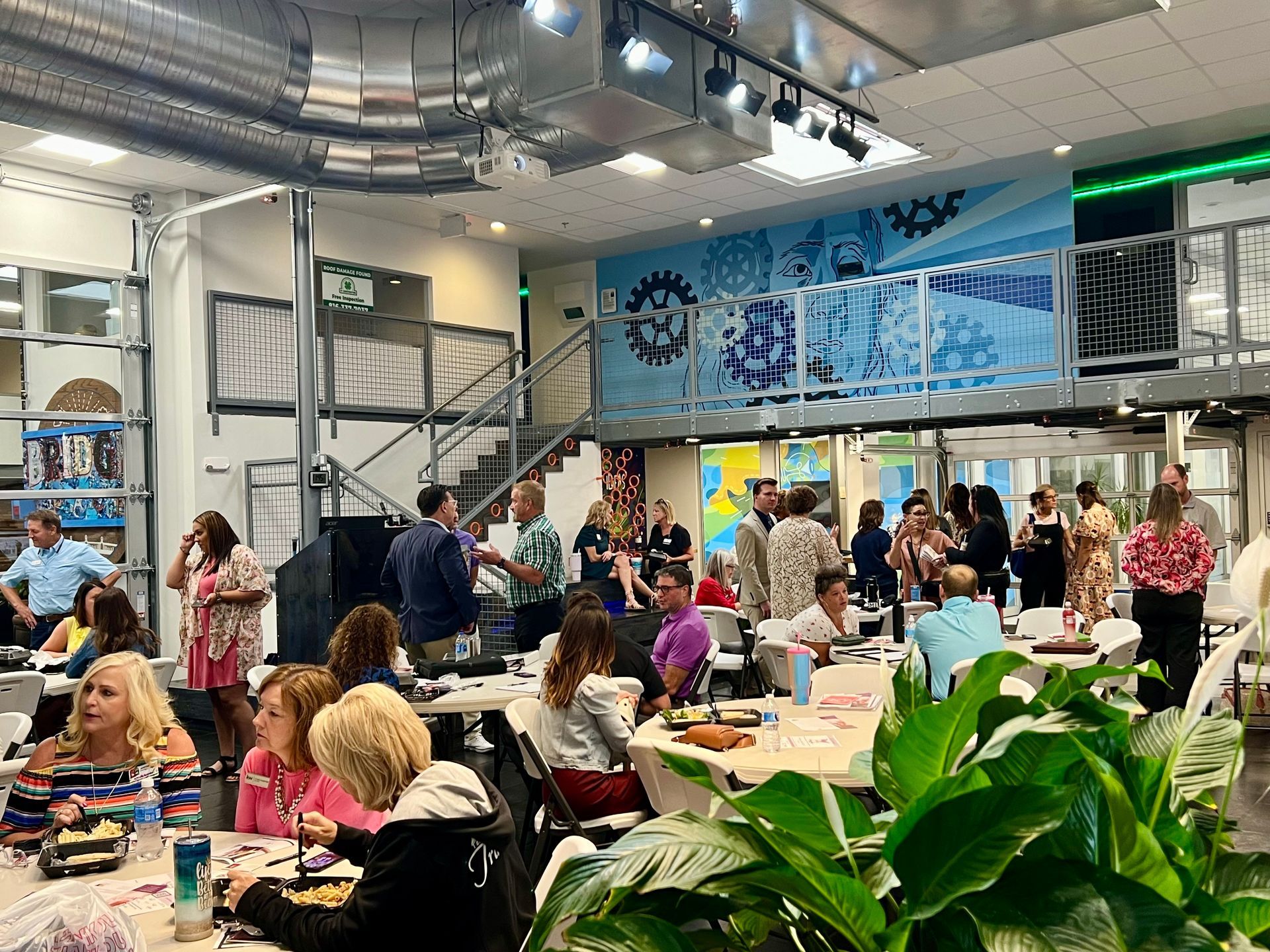 people standing inside a lees summit event space networking