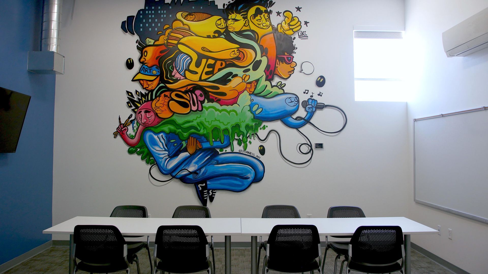 bridge space lees summit conference room with a mural on the wall