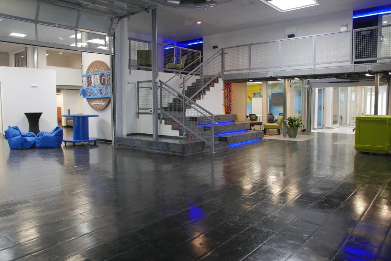 A large room with stairs leading up to the second floor