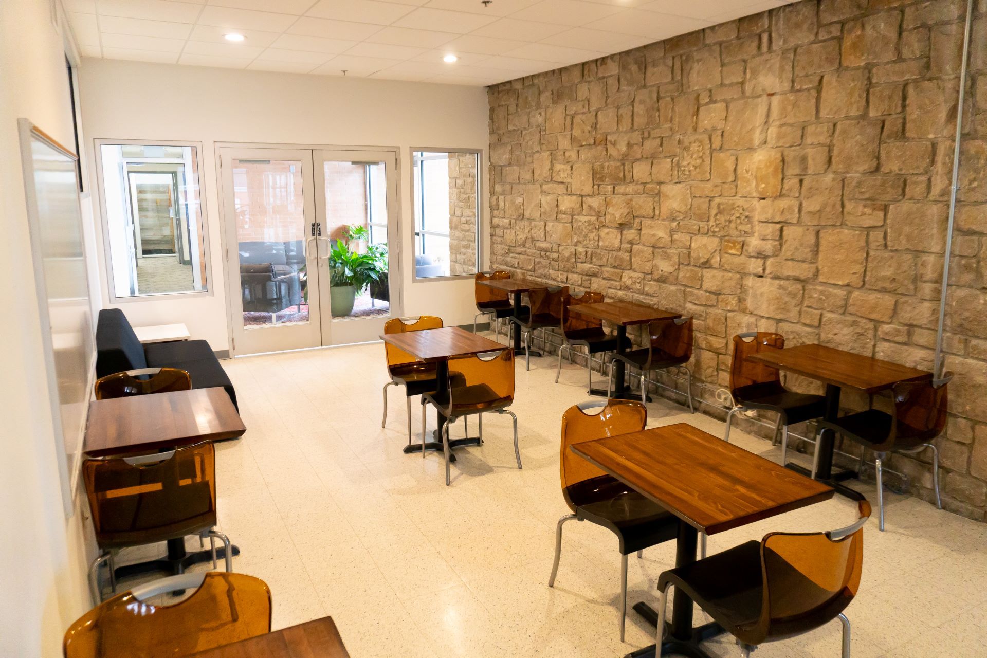 large size conference room with brick walls with tables and chairs
