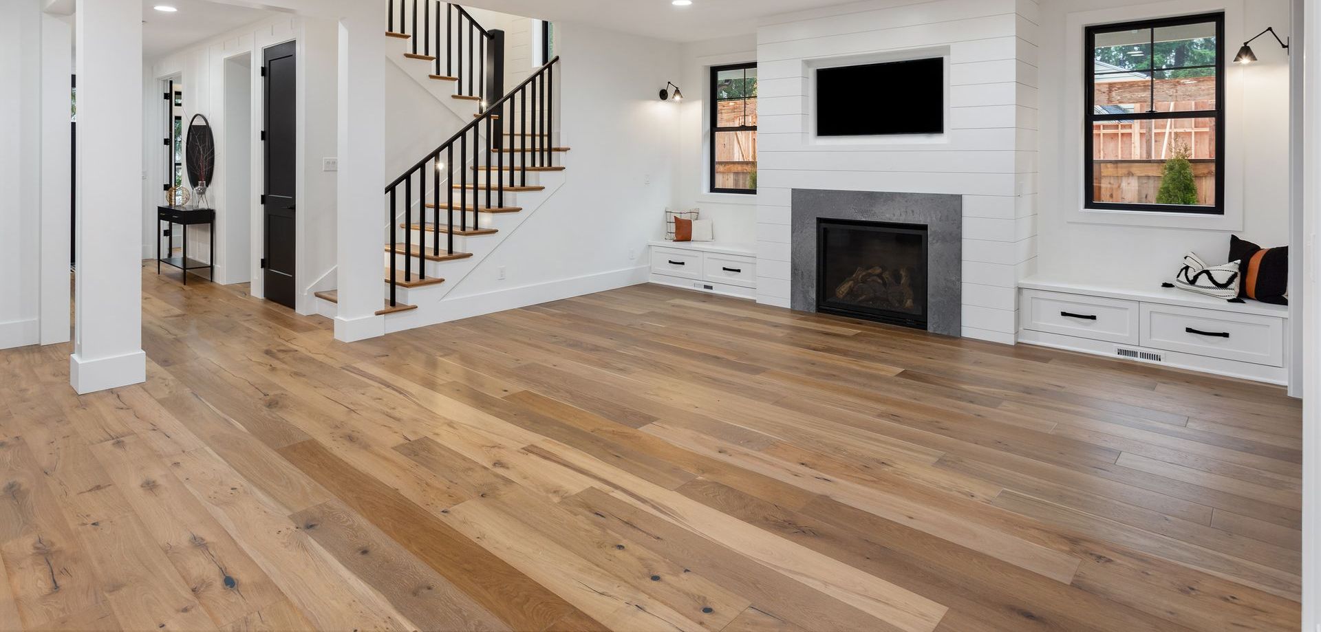 a living room with hardwood floors and a fireplace