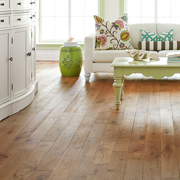 a living room with hardwood floors and a white couch