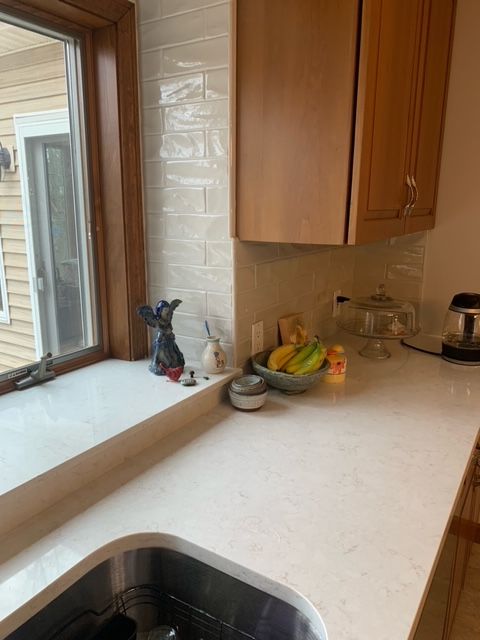 a kitchen counter with a sink and a window