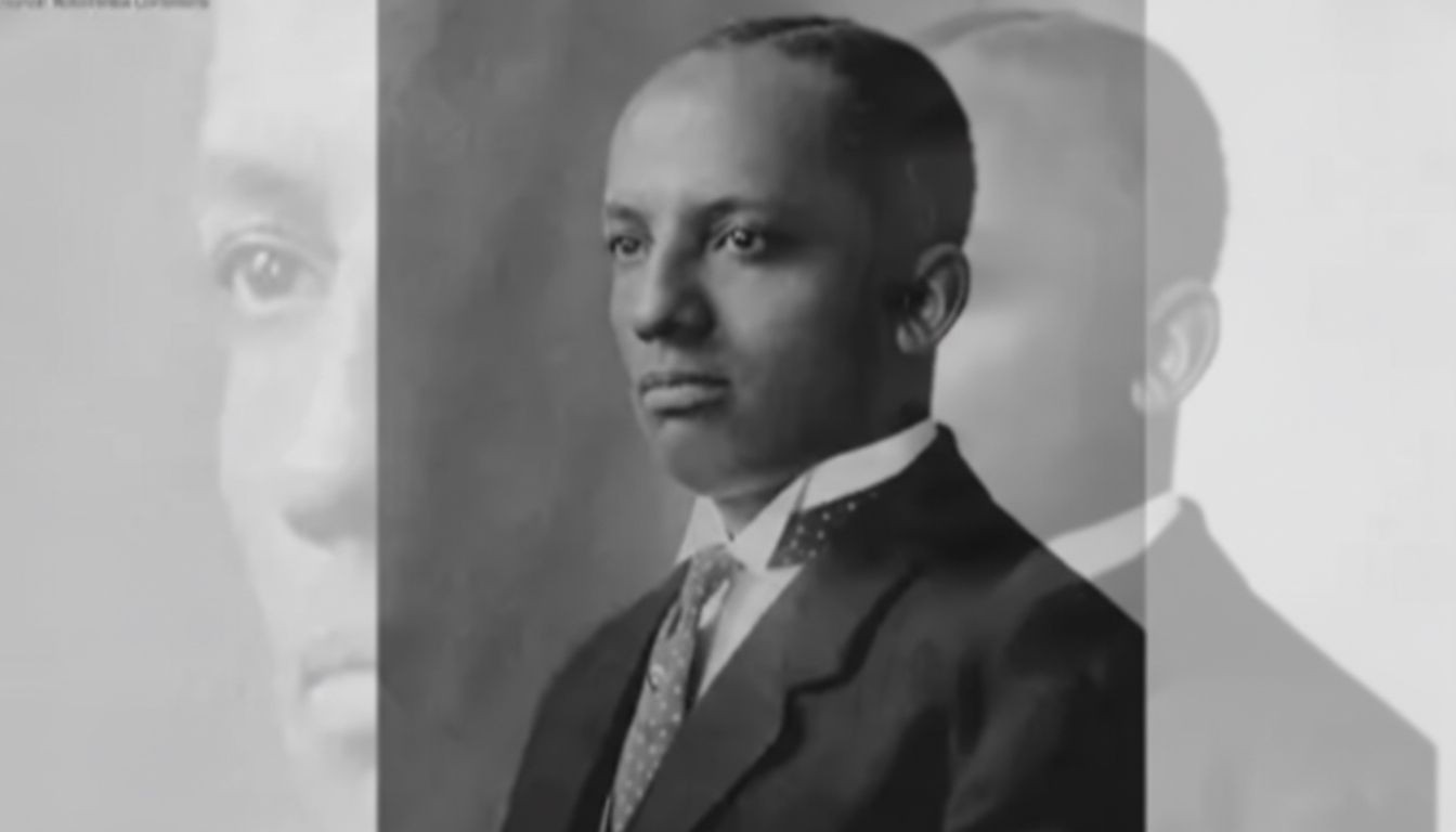 Carter G. Woodson Portrait of a man in a suit and tie, looking serious. A faded duplicate image is on the left.