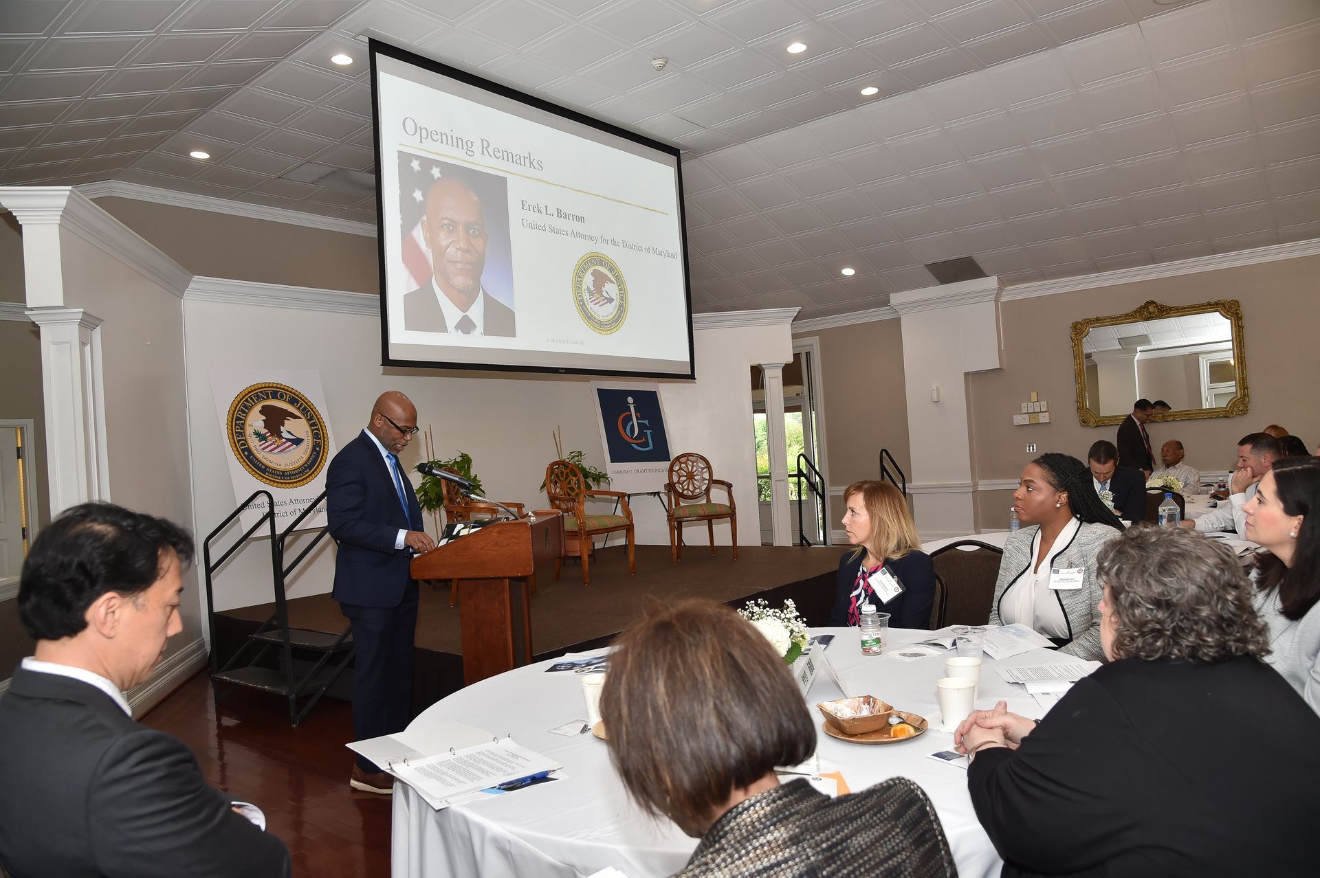 A man is giving a presentation to a group of people in a room.