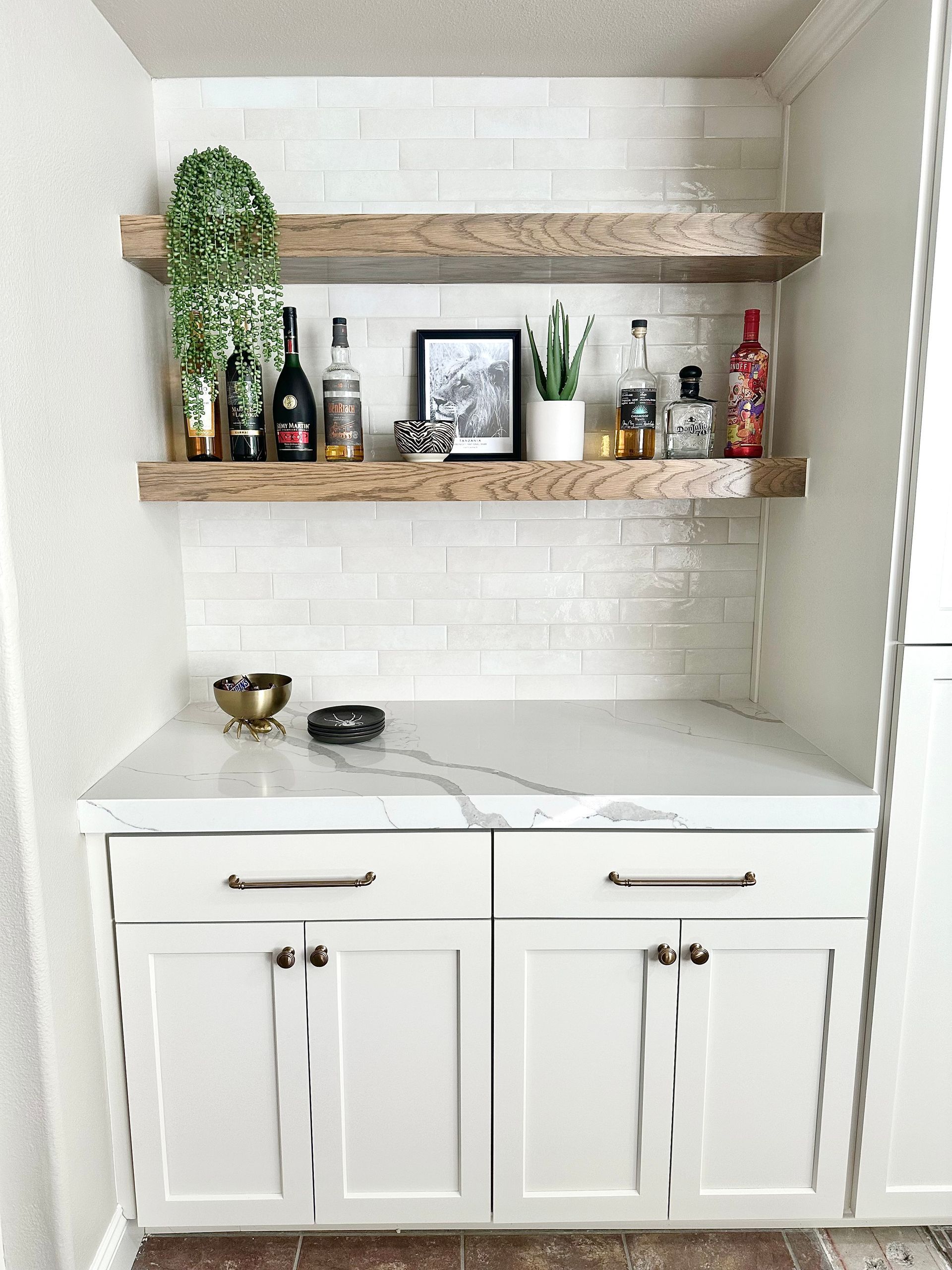 Bright modern kitchen with white cabinets and a large island table in the center