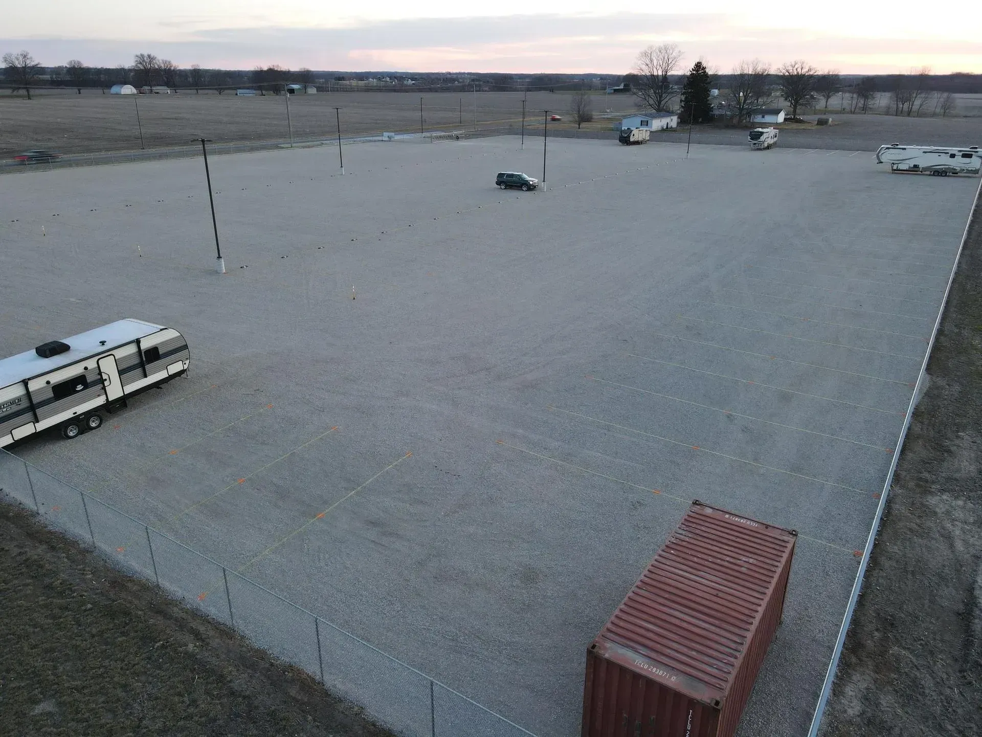Secure, fenced outdoor RV storage with parking lanes.