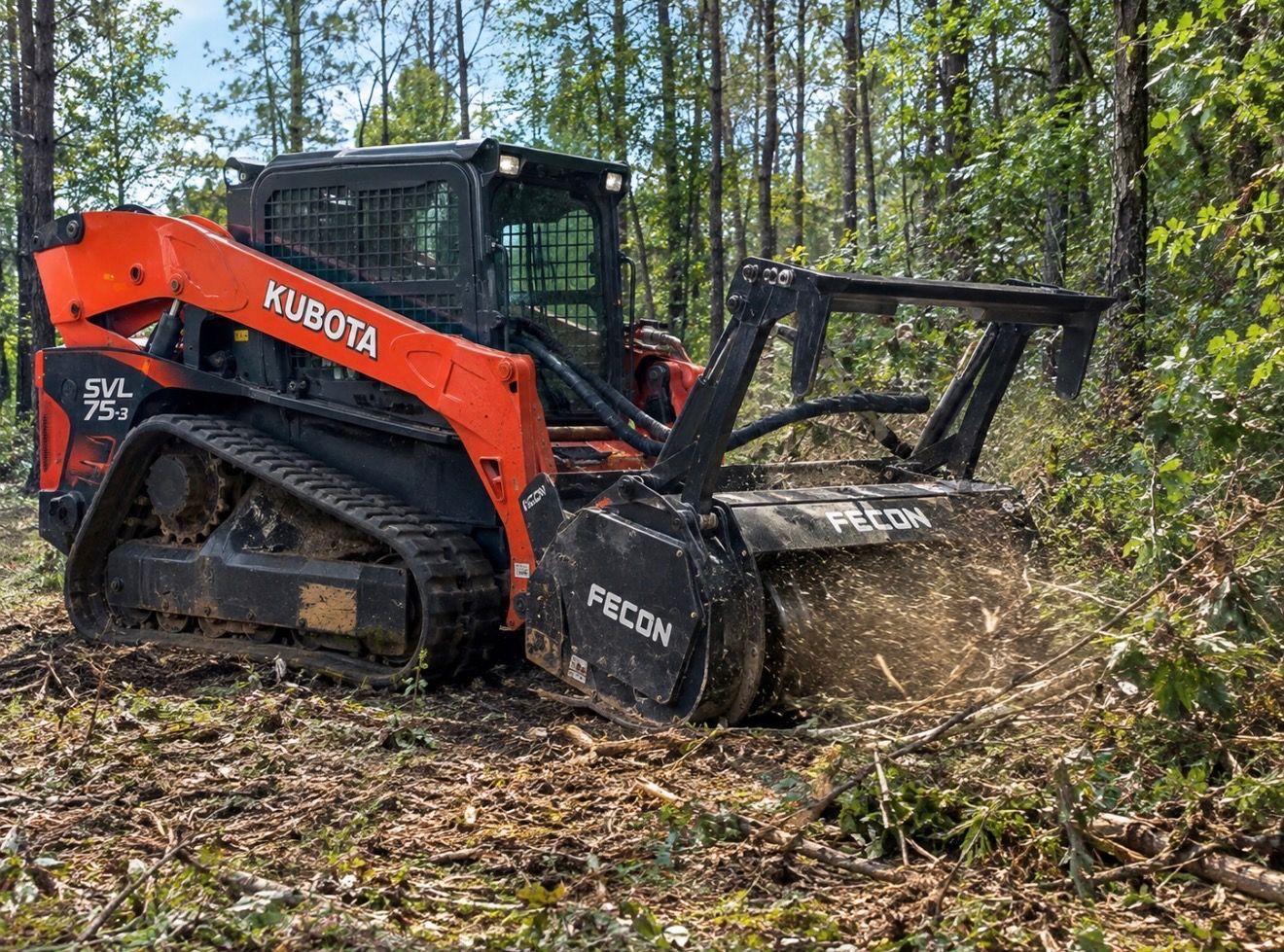 Orange skid steer moving dirt in a wooded forest clearing on a sunny day