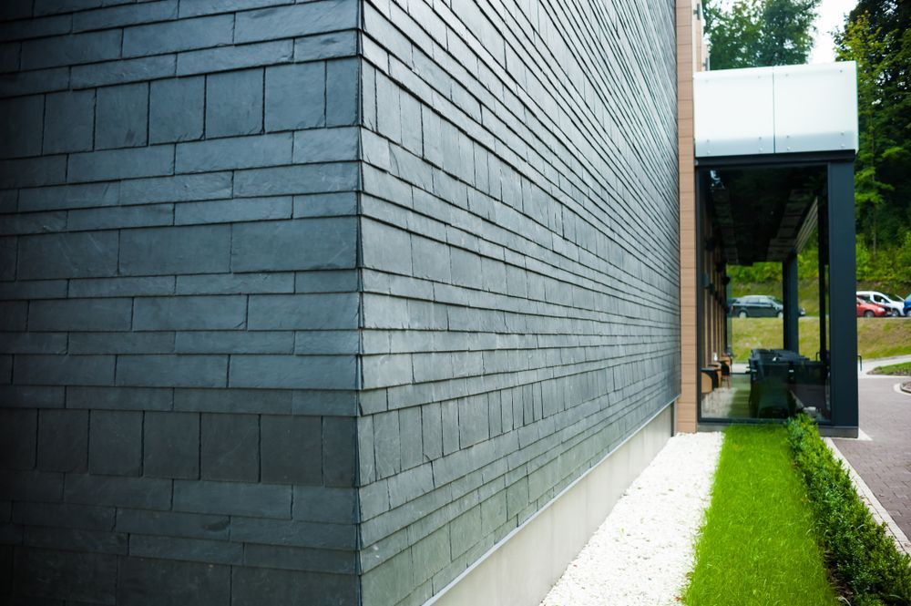 Dark Grey Slate Wall on a Building's Corner With Green Grass — MJD Roofing Sunshine Coast in Cooroy, QLD