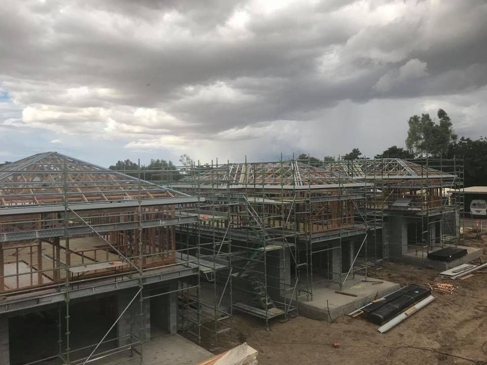 Buildings Under Construction, Grey Concrete, Scaffolding — MJD Roofing Sunshine Coast in Cooroy, QLD