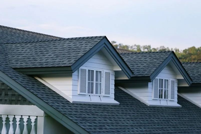 Gray Shingled Roof With White Dormers, Two Windows — MJD Roofing Sunshine Coast in Cooroy, QLD