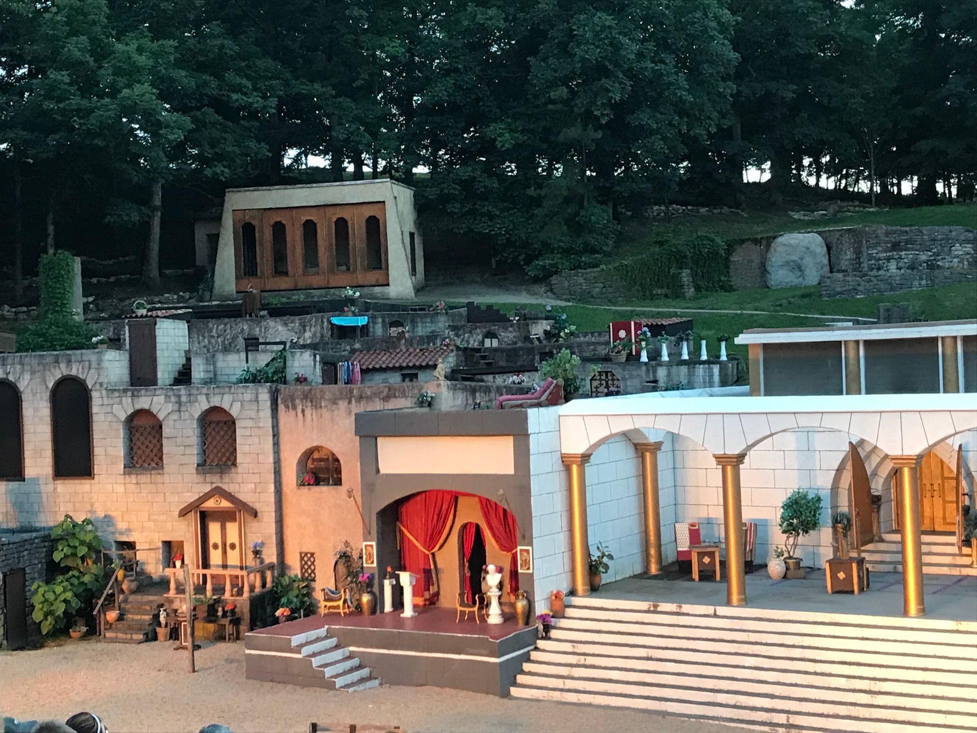 A stage with a red curtain and stairs leading up to it