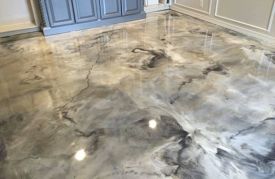 Glossy marbled concrete floor with gray, white, and black swirls near blue cabinets