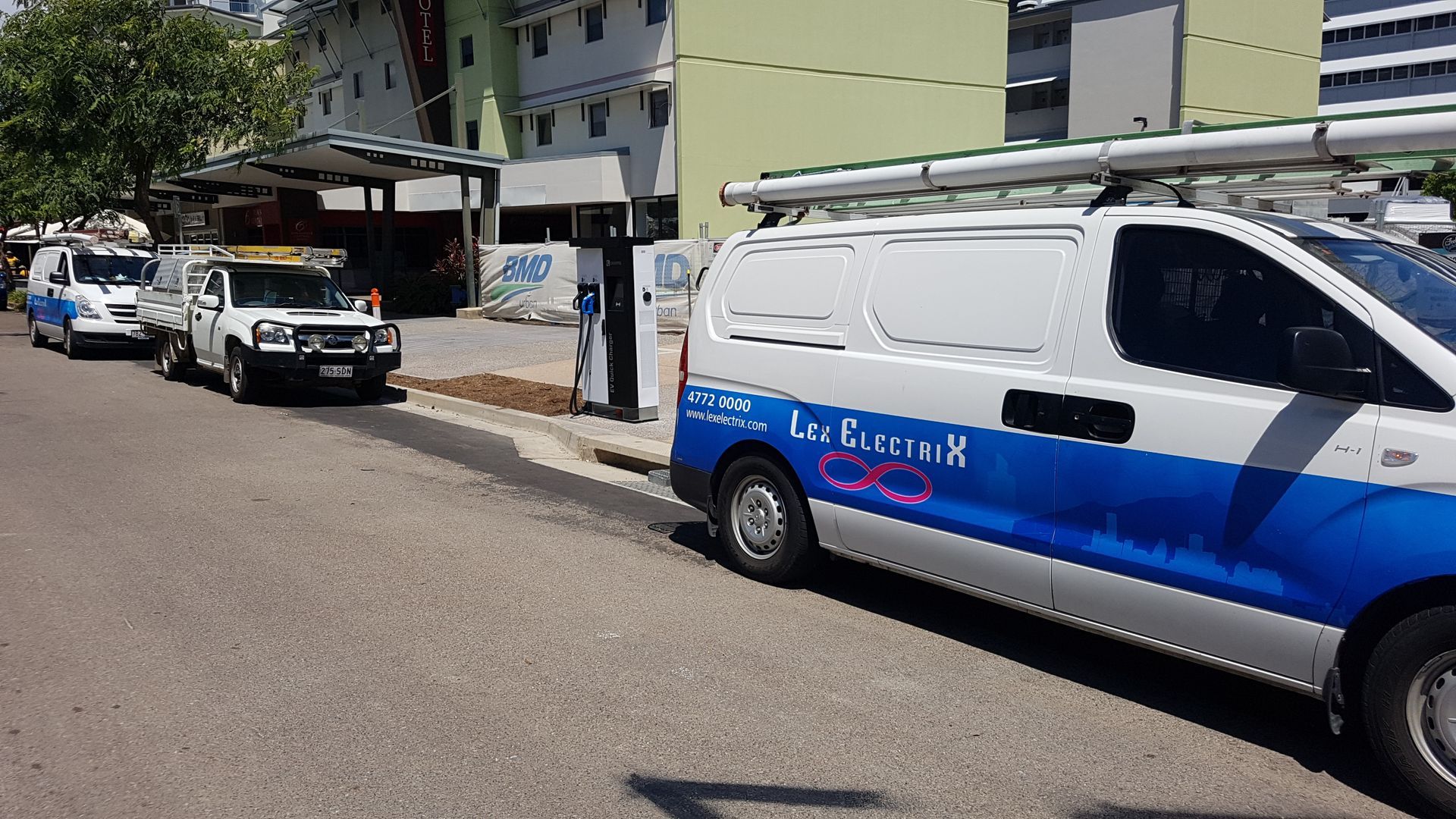 An EV Charger With A White Van Either Side— Lex Electrix In West End, QLD