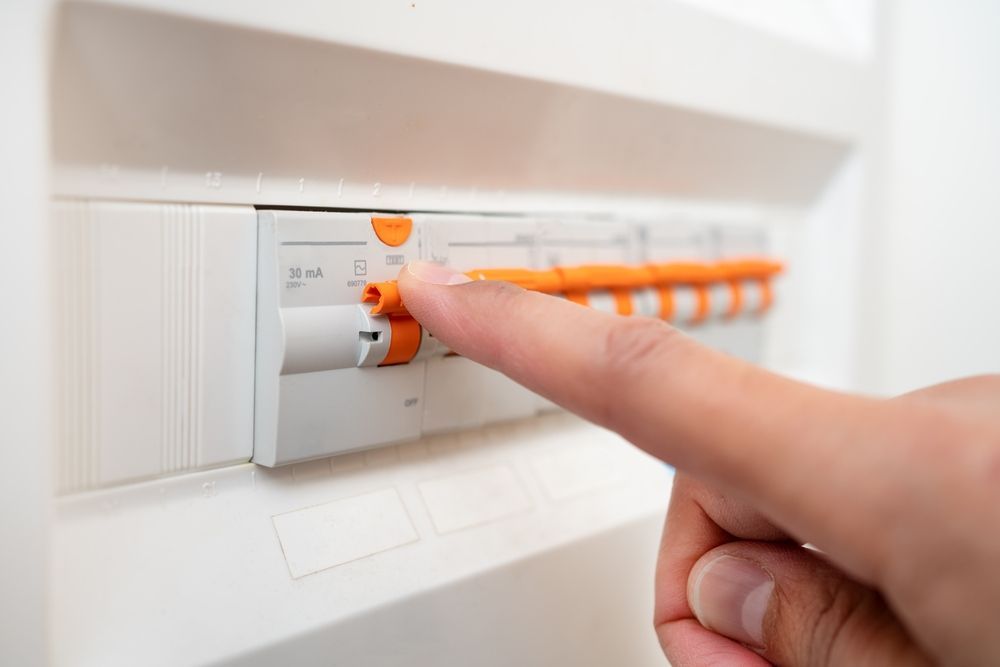 A Person Is Pressing A Button On An Electrical Box With Their Finger โ Lex Electrix In West End, QLD