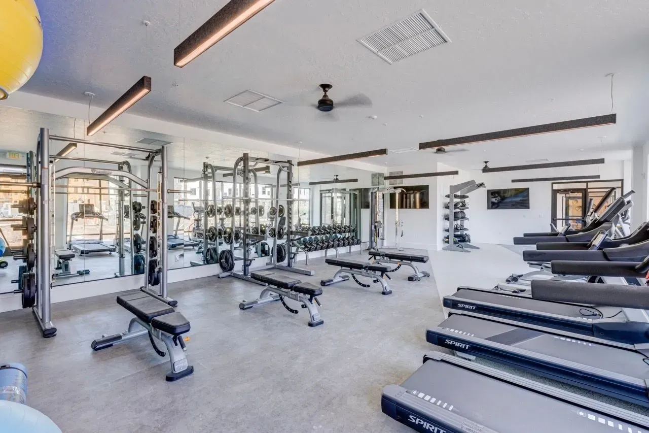 Fitness center with treadmills, weight machines, and free weights at Aria in Syracuse, UT.
