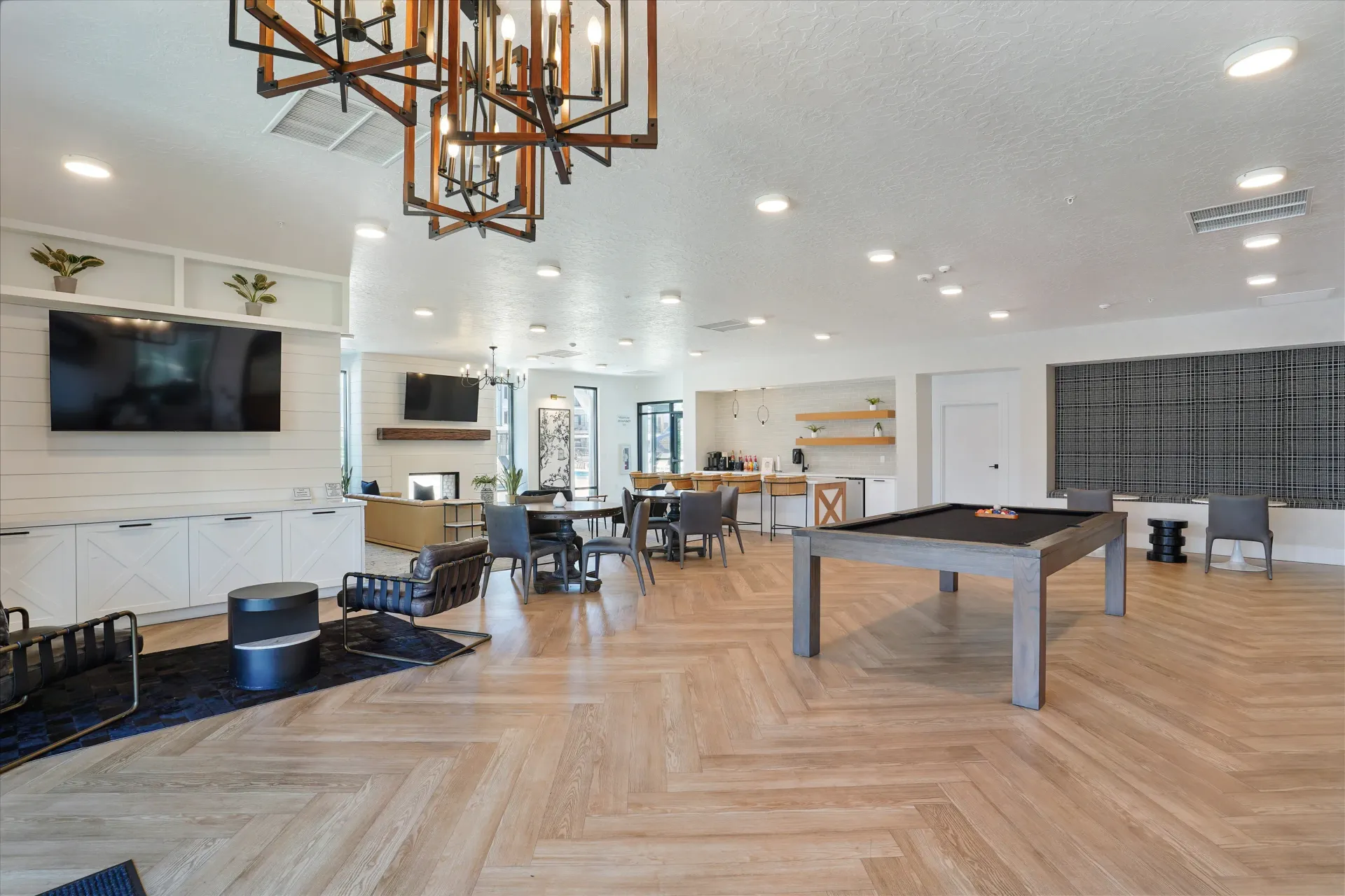 Spacious community lounge with a pool table, seating areas, and a coffee bar at Aria in Syracuse, UT.