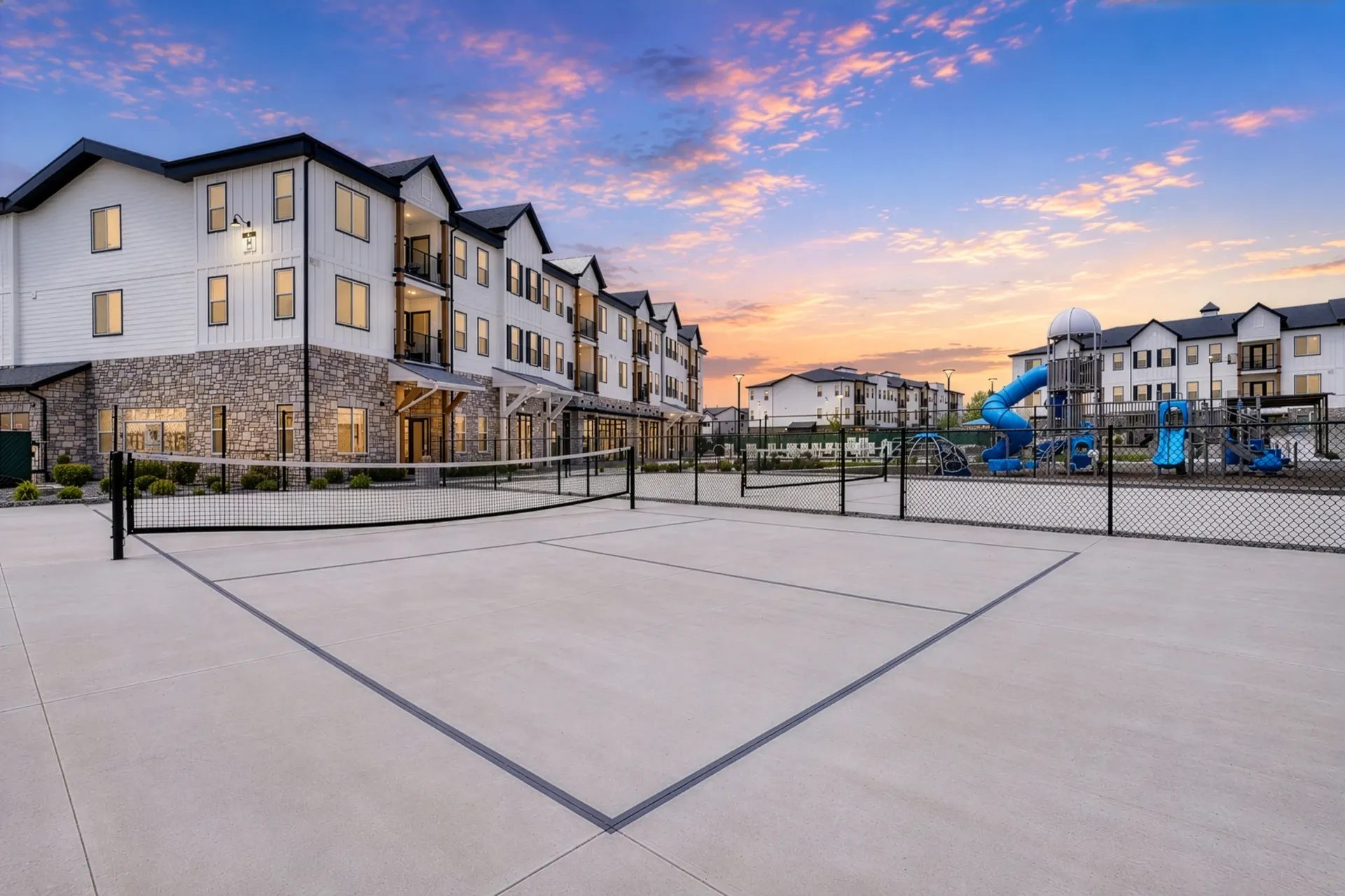 Outdoor court with pickleball lines and a playground at Aria in Syracuse, UT.