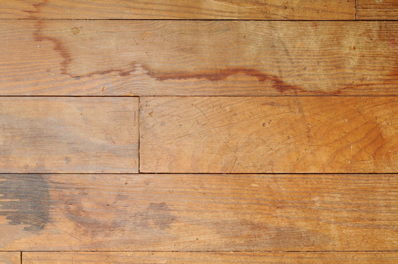 Close-up of weathered wooden planks with warm brown tones and visible grain texture