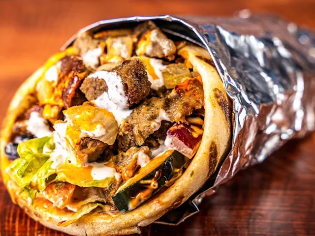 Shawarma wrap with various fillings, wrapped in foil.