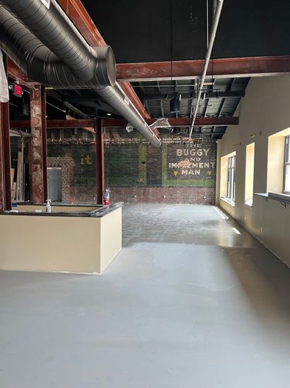 An empty room with a sign on the wall that says buggy.