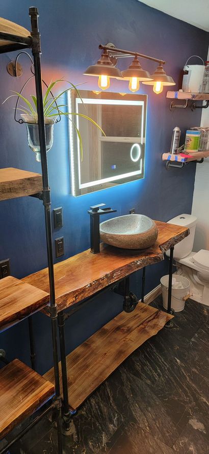 A bathroom with a sink , mirror and toilet.
