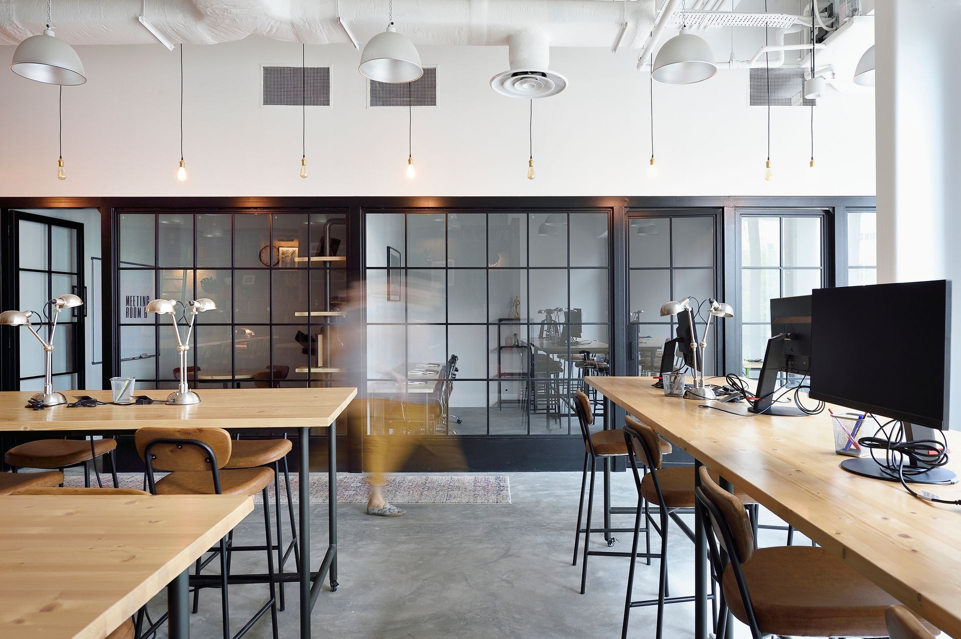 A room with a lot of tables and chairs in it
