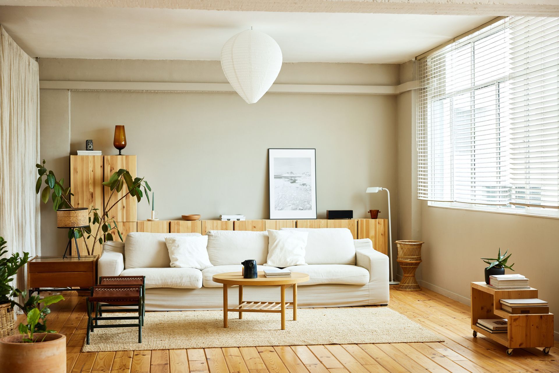 A living room with a couch , table , and window.