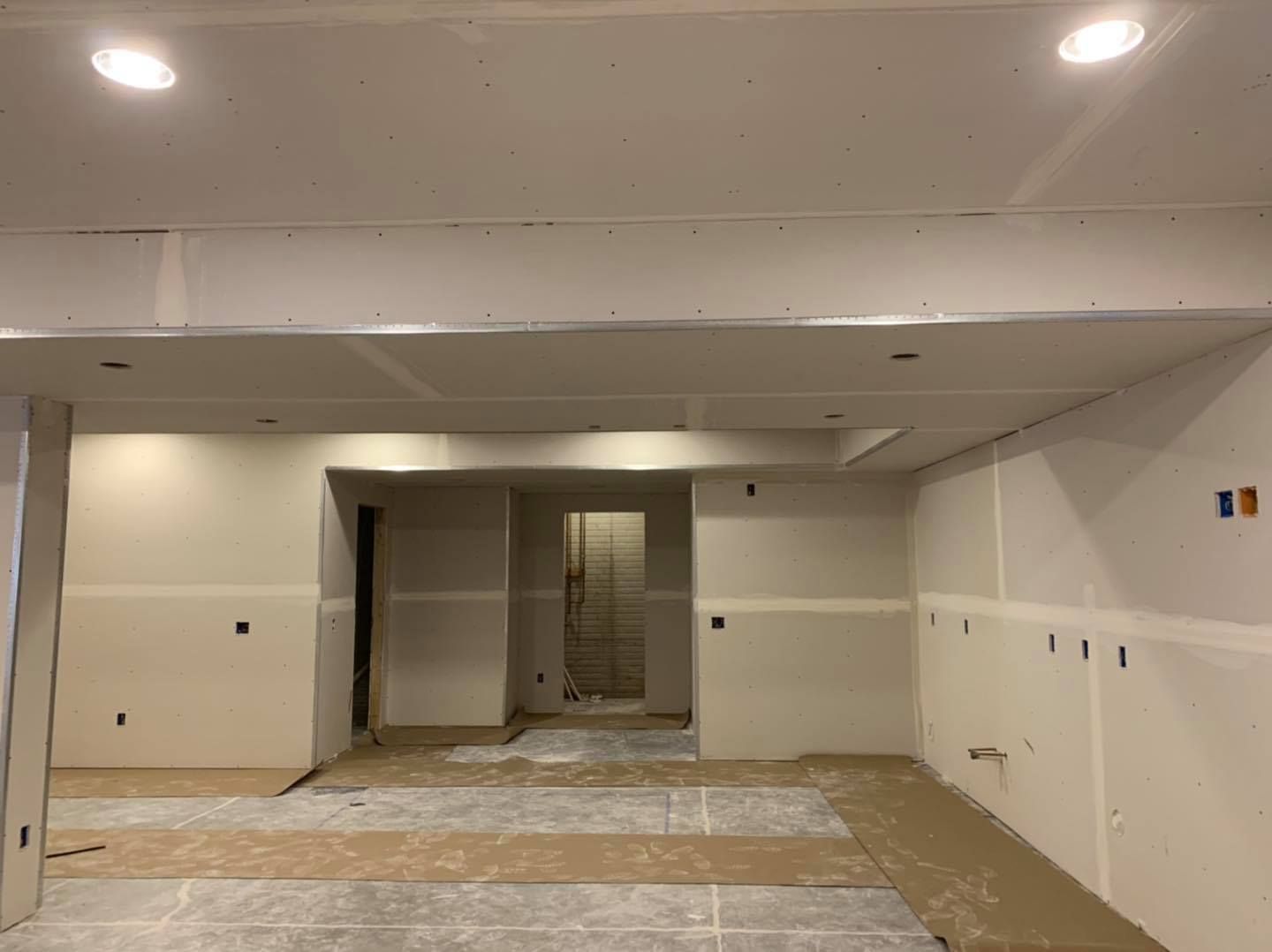 A large room with a ceiling that is being built.