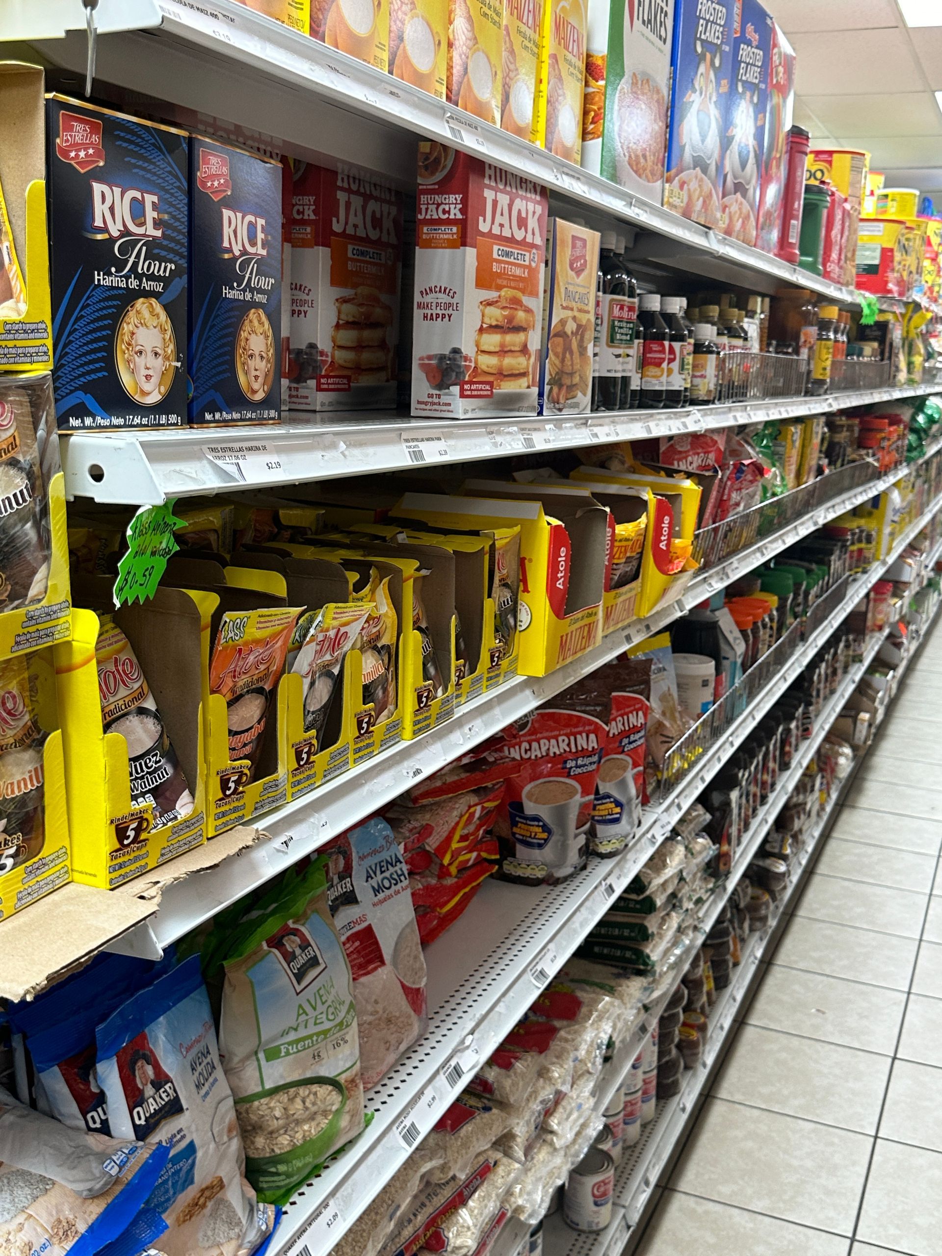 Shelves stocked with various food products in a grocery store aisle.