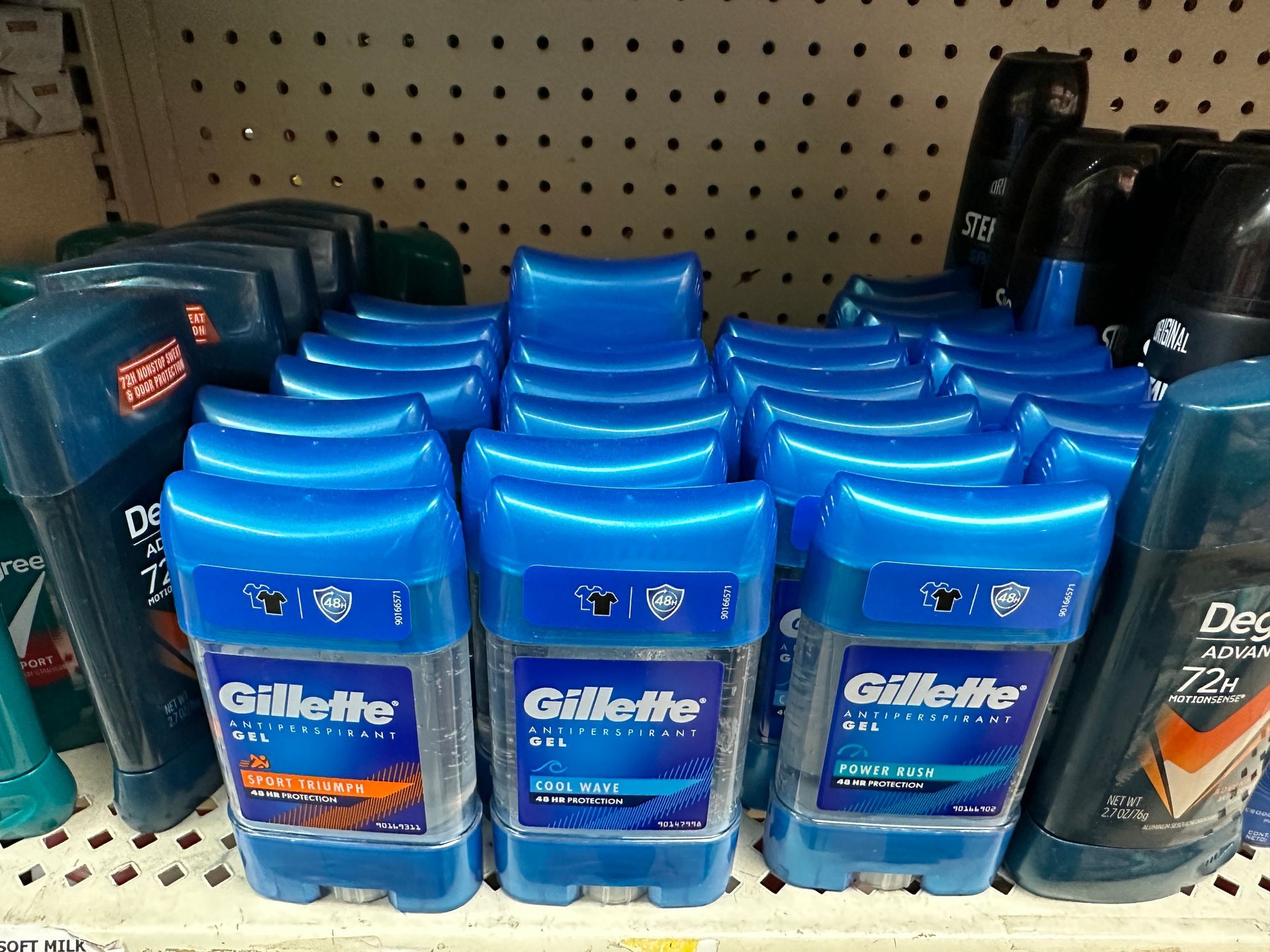 Gillette deodorant sticks in blue packaging on a store shelf.