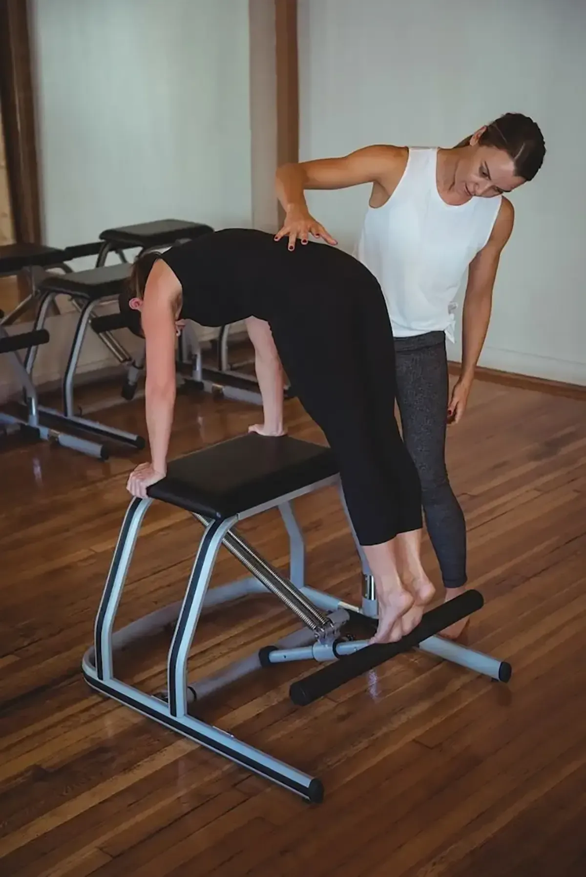 Woman smiling during Pilates on a reformer in a studio