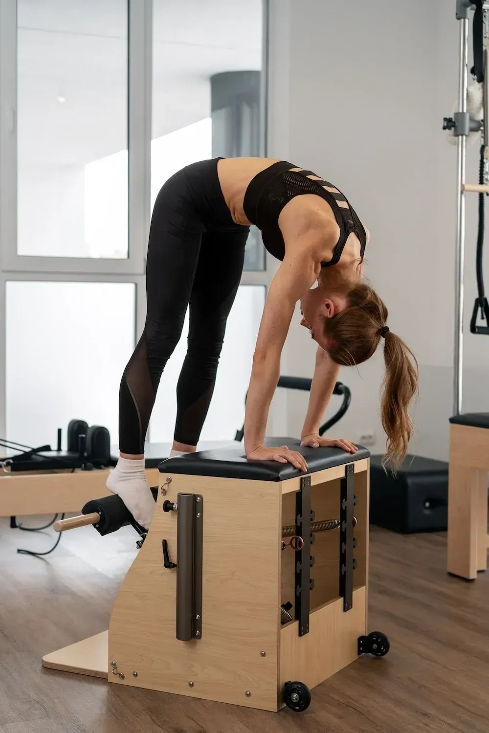 Woman smiling during Pilates on a reformer in a studio