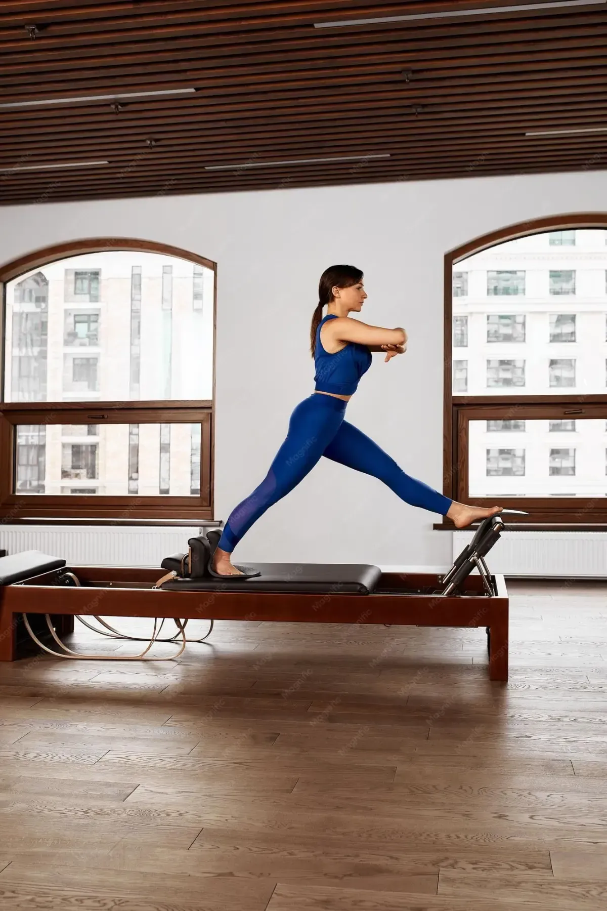 Woman smiling during Pilates on a reformer in a studio