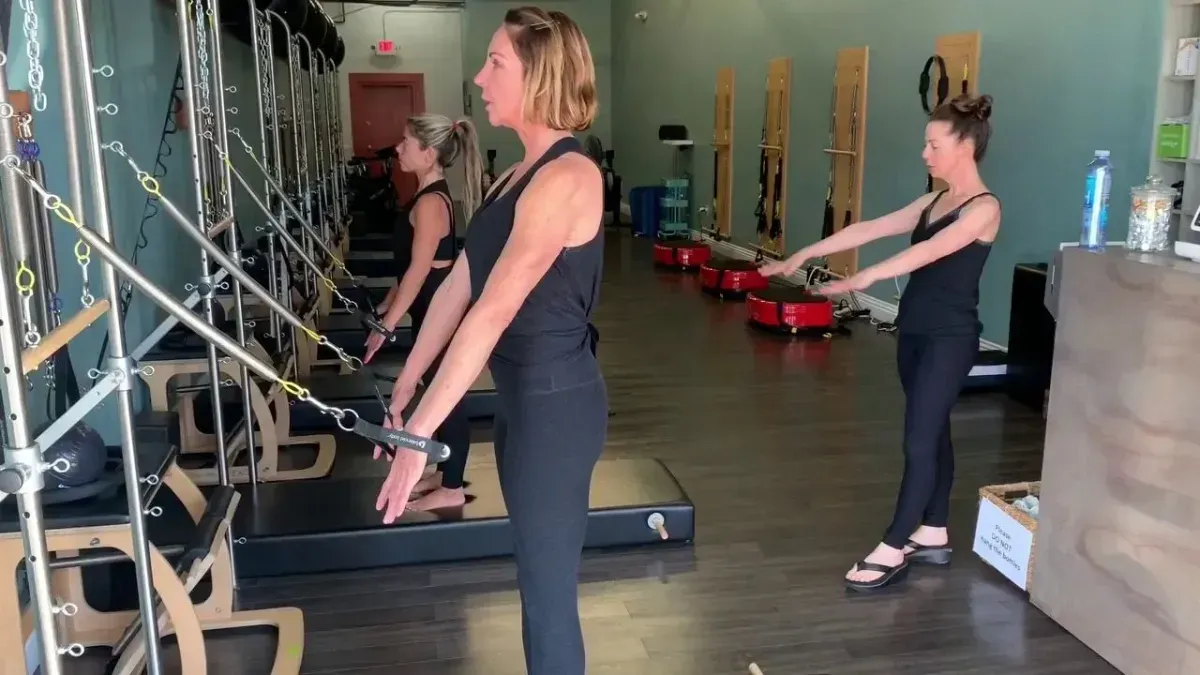 Woman smiling during Pilates on a reformer in a studio