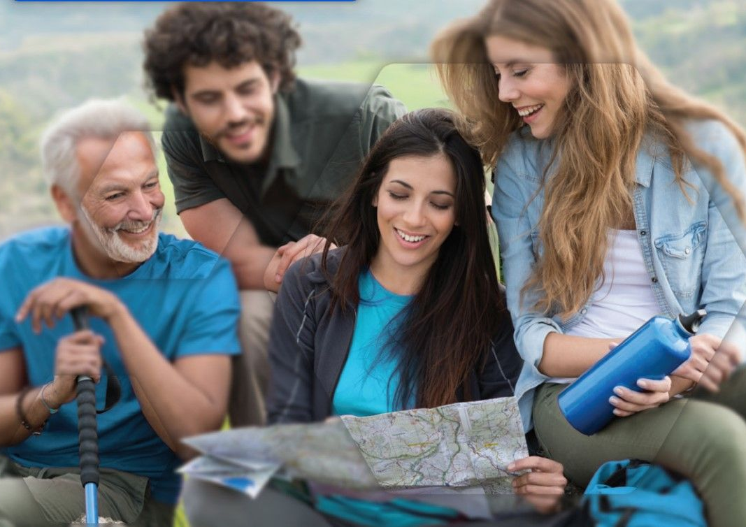 Group of hikers looking at a map outdoors; smiles, blue water bottle, green and blue clothing.