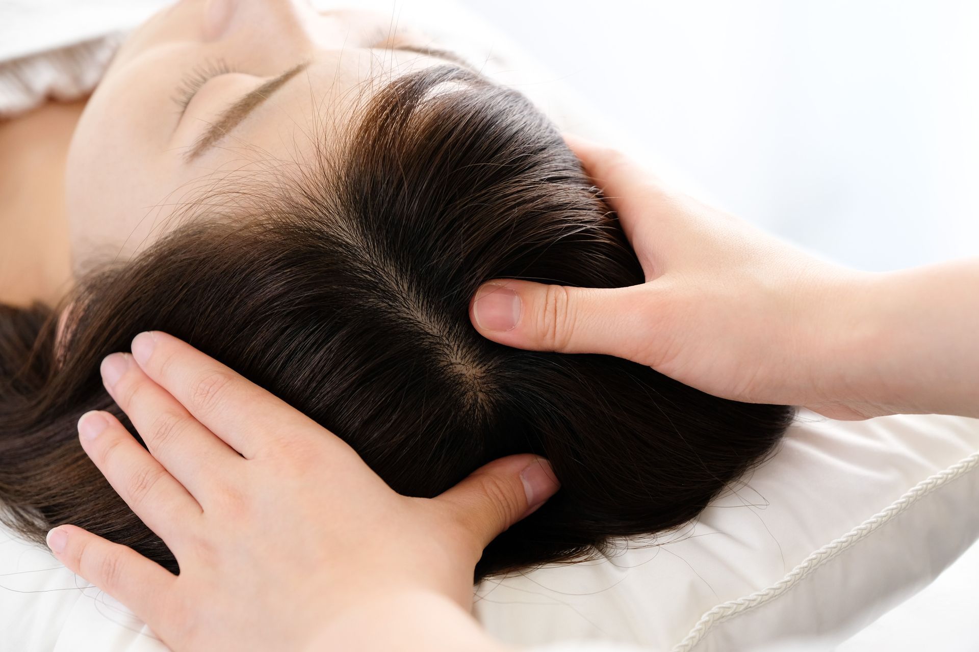 A woman is getting her hair examined for the treatment.