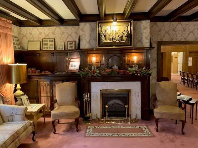 A living room with a fireplace and chairs