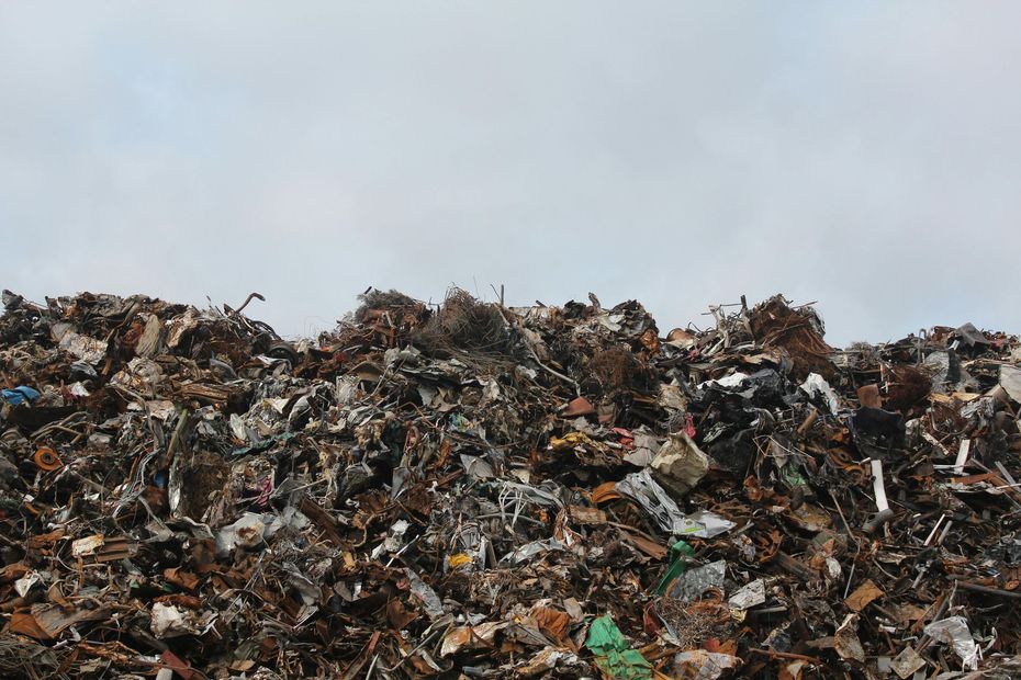 Pile of scrap metal against a cloudy sky.