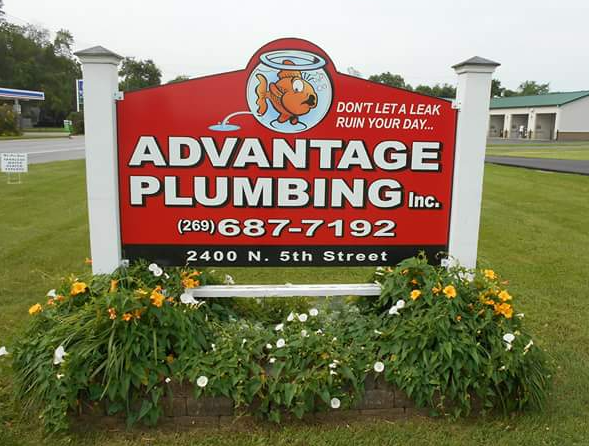 Sign for Advantage Plumbing with a goldfish logo, red background, phone number, and street address.